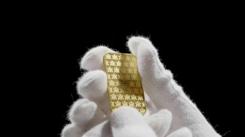 Precious Metals One Ounce Bar 99.999 Fine Gold 1Oz Gold Bar in Hand Stock Footage 129513859