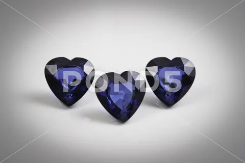Precious sapphire carved in the shape of a heart . Stock Photos