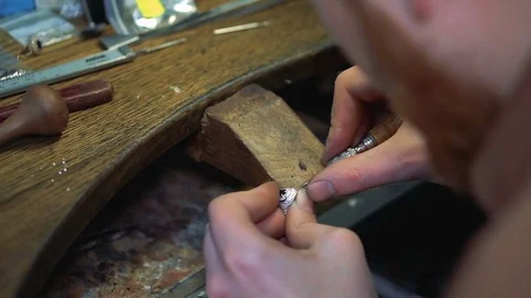 Precious stone is fixed in a silver ring by the hands of goldsmith Video stock 73555067