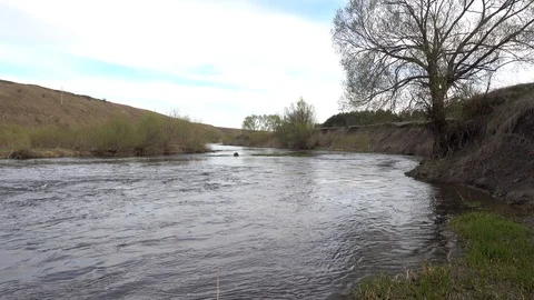 Precipitous riverside on rapid river bend at spring, 4K ultra hd video clip Stock Footage 85991619