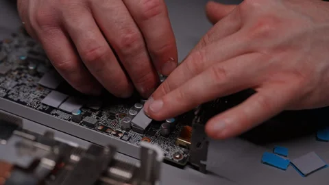 Precise application new thermal pad onto graphics processing unit - GPU chip by Stock Footage 290926799