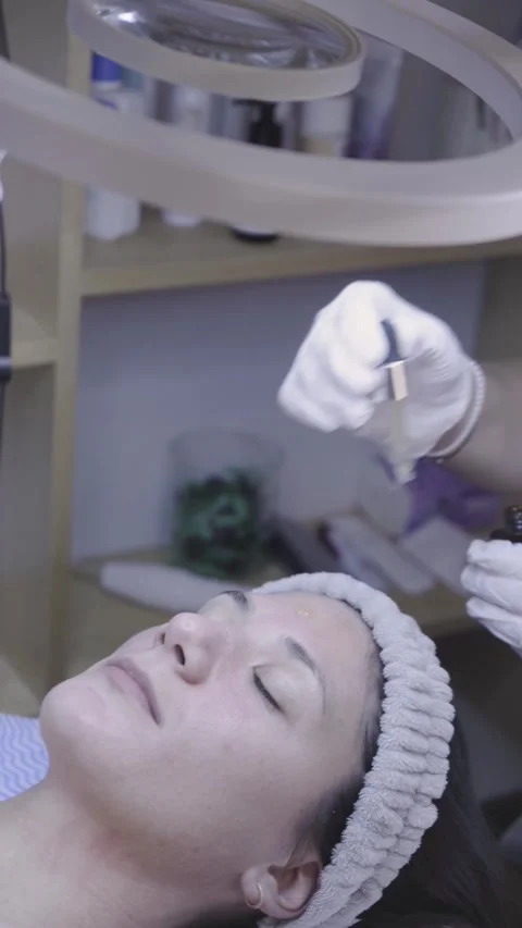Precise applicator glides gently along the eyelid in a tranquil skincare session Stock Footage 342820993