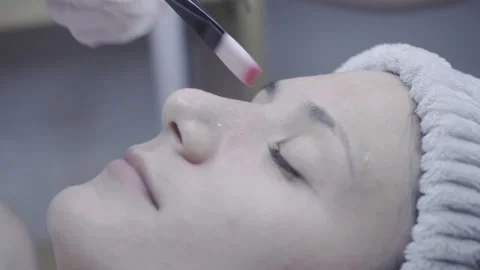 Precise cotton swab application during a relaxing facial treatment Stock Footage 342821207
