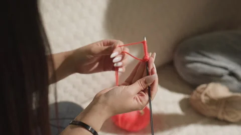 Precise framing highlighting hand movements while knitting, intimate depiction Stock Footage 323312926