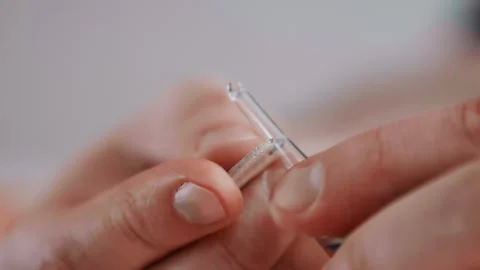 Precise medication preparation. Detailed image showing caregiver carefully Video stock 345530960