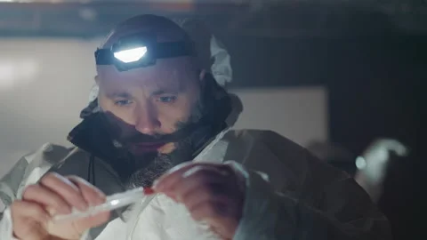 Precise nuclear handling. Skilled technician under dim light carefully inspects 動画素材 342741230