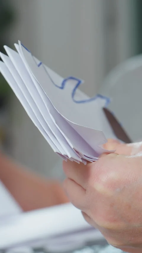 Precise scissors technique demonstrated on layered sheets, Educational scene Stock Footage 329405677