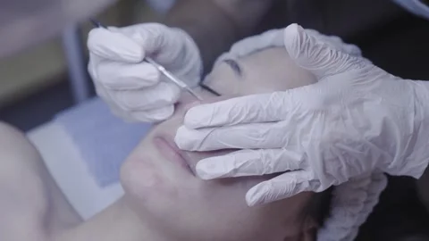Precise skincare tool tracing the cheek during a calming facial Vídeo Stock 342821325