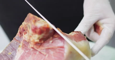 Precise slicing of traditional cured ham on white background Stock Footage 302353602