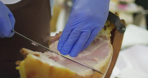Precise slicing of traditional cured ham on white background Stock Footage 302354441