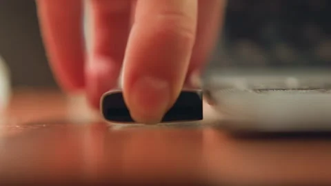 Precise USB drive being inserted into port. Slow motion shot capturing exact Stock Footage 342283639