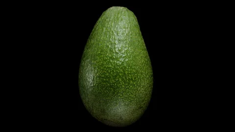 Precisely Cut Avocado Half with Pit Rotates on a Black Background in Close-up. I Stock Footage 262679514