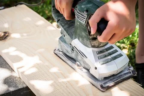 Precision in action as a power planer refines a wooden surface Stock Photos