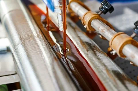 Precision and efficiency converge in a glue-spreading machine at work during Stock Photos