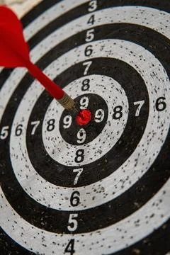 Precision and Focus: Achieving the Perfect Aim on a Dartboard with a Target.. Stock Photos