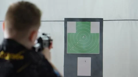 Precision and Focus in Target Practice at Indoor Shooting Range Video stock 310494314
