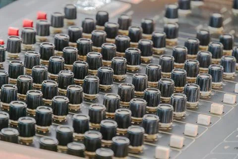 Precision Audio Mixing Console Close-Up with Black Knobs and Red Caps Stock Photos
