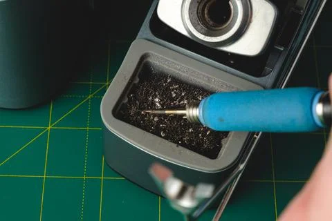 Precision cleaning of a mechanical pencil sharpener in a well-lit workspace Stock Photos