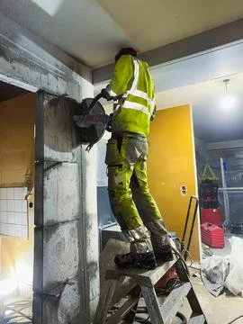 Precision concrete cutting during building renovation. Stock Photos