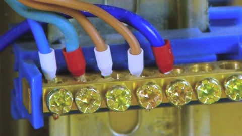 Precision Connections Securing Vibrant Power Cables on a Blue Terminal Stock Footage 340482187