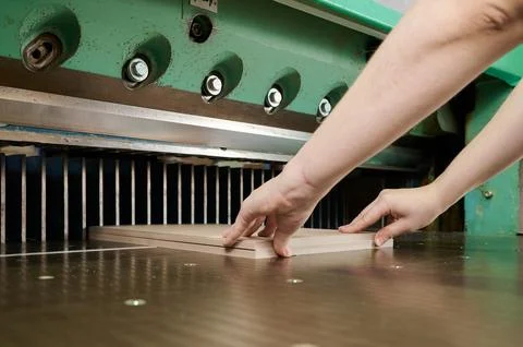 Precision cutting of cardboard sheets using guillotine shears in a modern Stock Photos