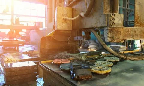 Precision cutting of materials in a workshop during golden hour light Stock Photos
