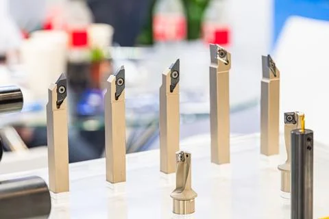 Precision cutting tools arranged neatly on reflective surface, metallic she.. Stock Photos