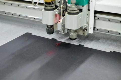 Precision cutting on a wide format CNC plotter for intricate designs in a modern Stock Photos