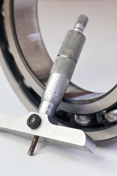Precision depth micrometer measuring a ball bearing isolated on white backg.. Stock Photos