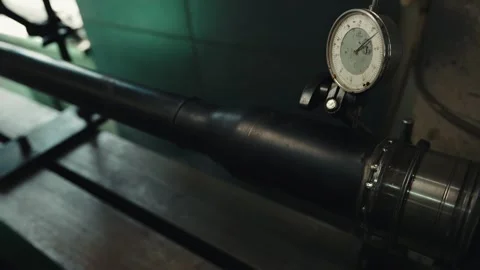 Precision dial indicator on an automobile drive shaft on a lathe Stock Footage 281581592