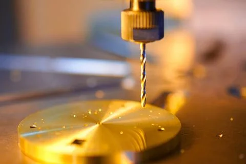 Precision drilling of a clockwork base reveals the artistry of metalworking in Stock Photos