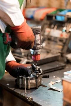 Precision Engineering: A Craftsman Using a Drill on Machinery Components Stock Photos