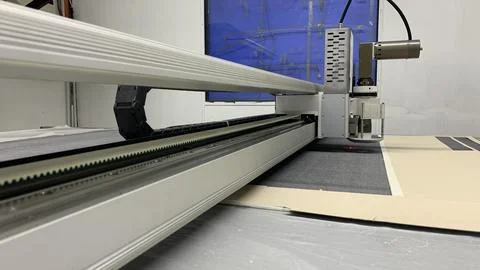 Precision fabric cutting with automated machine for textile manufacturing Stock Photos