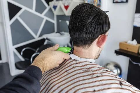 Precision fading at the nape using electric clippers, ideal for concepts of h Stock Photos