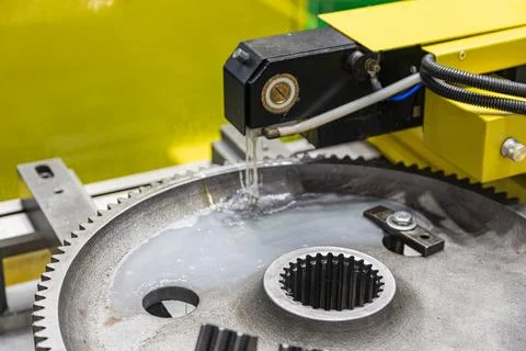 Precision gear machining process in industrial workshop, large metallic gea.. Stock Photos