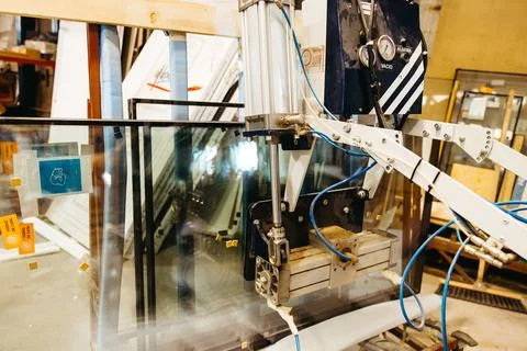 Precision glass assembling machine in aluminum window manufacturing workshop Stock Photos