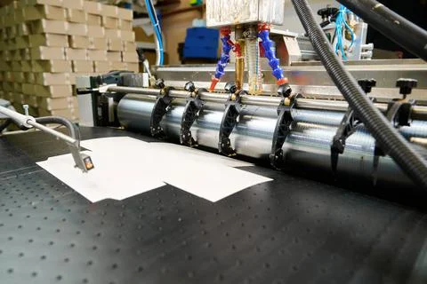 Precision glue applicator efficiently spreads adhesive on materials in a modern Stock Photos