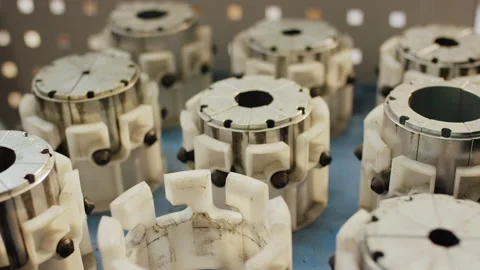 Precision industrial cylindrical metal components with white plastic fixtures Video stock 155207480