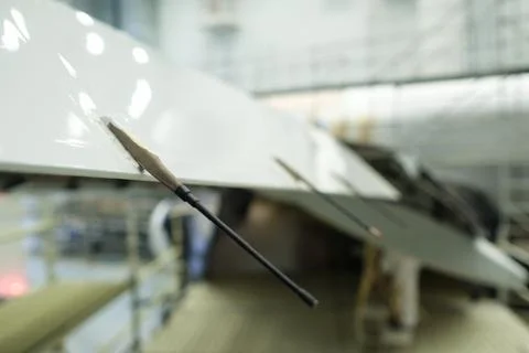 Precision instruments attached to a sleek aircraft wing inside a modern Stock Photos