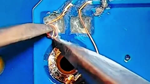 Precision Jumper Wire Repair on Smartphone Motherboard Stock Footage 333610556