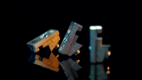 Precision machined metal components on dark reflective surface, industrial parts Vídeo Stock 342289125