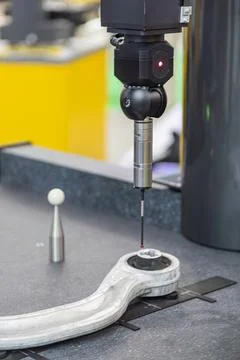 Precision measurement technology, robotic arm, metallic component, red lase.. Stock Photos