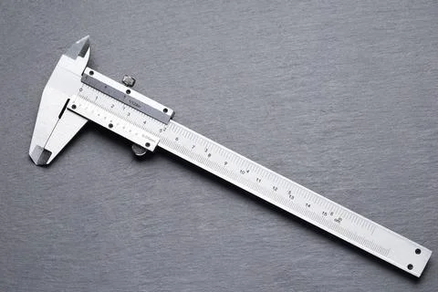 Precision Measuring Tool on Gray Slate Surface Stock Photos