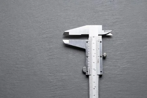 Precision Measuring Tool on Gray Slate Surface Stock Photos