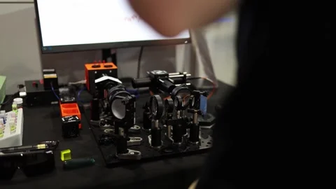 Precision optical lab setup with lenses mirrors and sensors mounted on a laser b Stock Footage 311047198