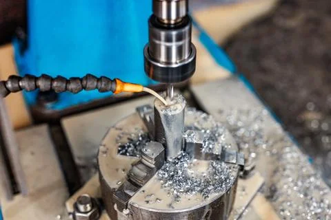 Precision in Progress A milling machine etches metal with a mist of coolant.. Stock Photos