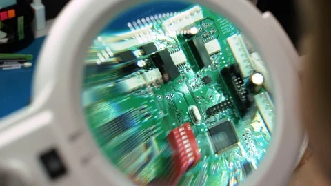 Precision quality control on printed circuit board with magnifying glass Video stock 101945023