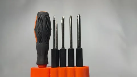 Precision screwdriver set with interchangeable bits in orange holder Stock Footage 345858669