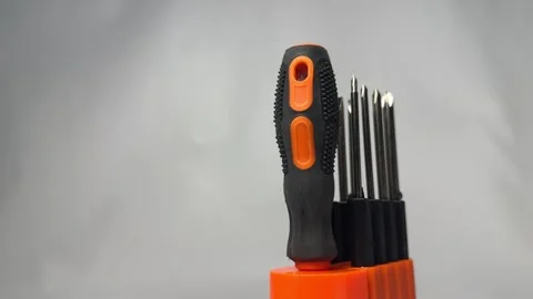 Precision screwdriver set with interchangeable bits in orange holder Stock Footage 345858718
