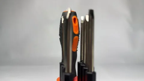 Precision screwdriver set with interchangeable bits in orange holder Stock Footage 345858735